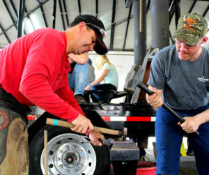 Chad Rice, CJF, left, works on a shoe with the aid of a striker. (Photo courtesy of WCB)