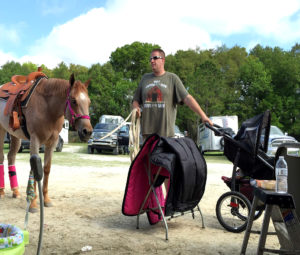Horse husband Brian Rosati multitasking at an AQHA show (Photo: contributed).