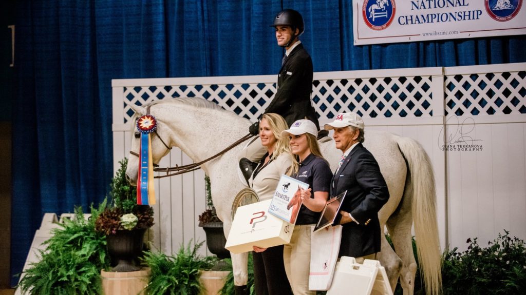 Quinn Lowsky in the irons after placing first in novice equitation on the flat. Pictured with him are SCAD Head Coach Ashley Henry (left) and IHSA Executive Director Bob Cacchione.